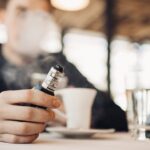 Man Vaping in Cafe