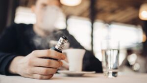 Man Vaping in Cafe